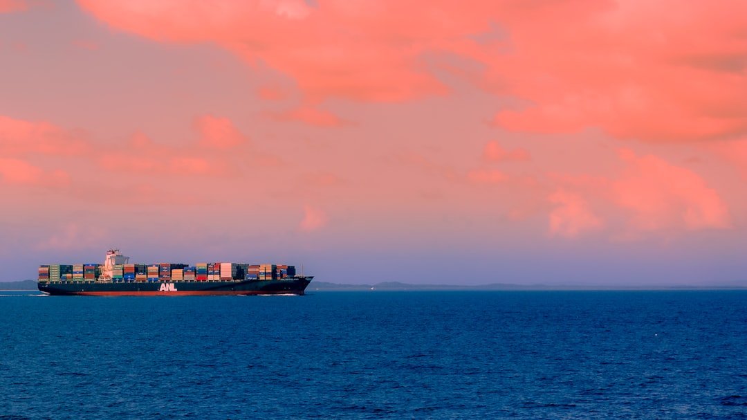 Cargo ship carrying international export containers at sea